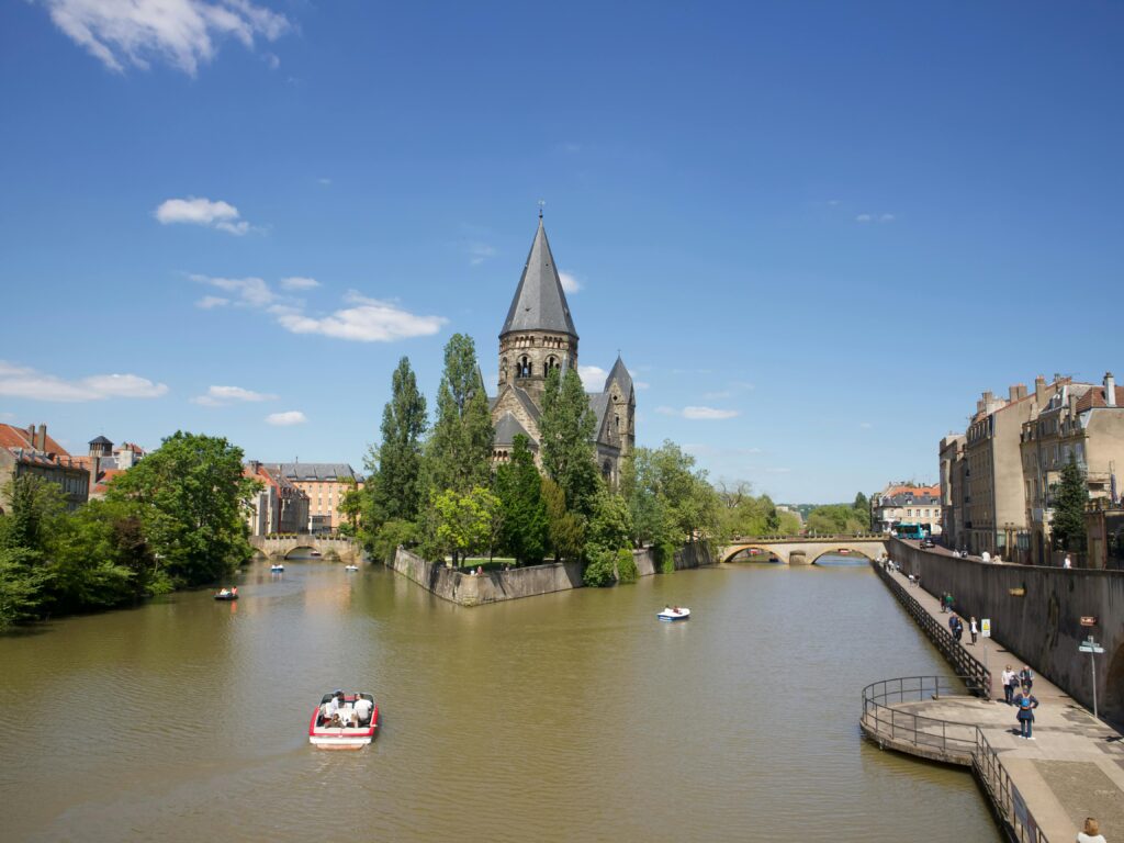 Metz Beautiful view of Temple Neuf by the canal in Metz, France on a sunny day.